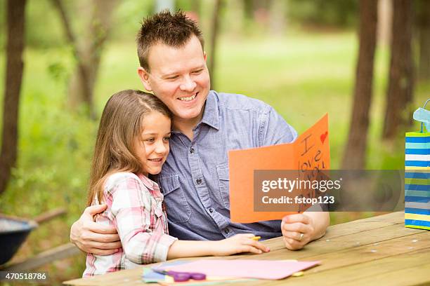 daughter shows dad handmade father's day card. outdoors. child, parent. - i love you card stock pictures, royalty-free photos & images