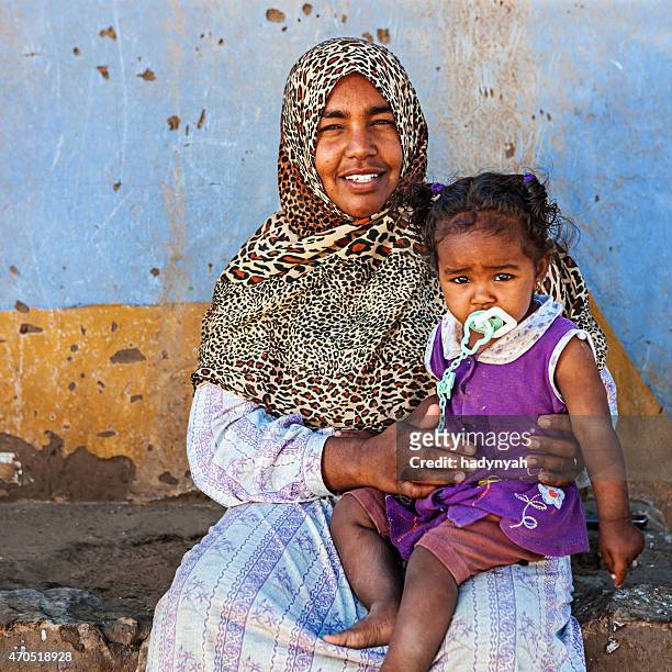 muslim woman holding her baby, southern egypt, africa - egyptian family stock pictures, royalty-free photos & images