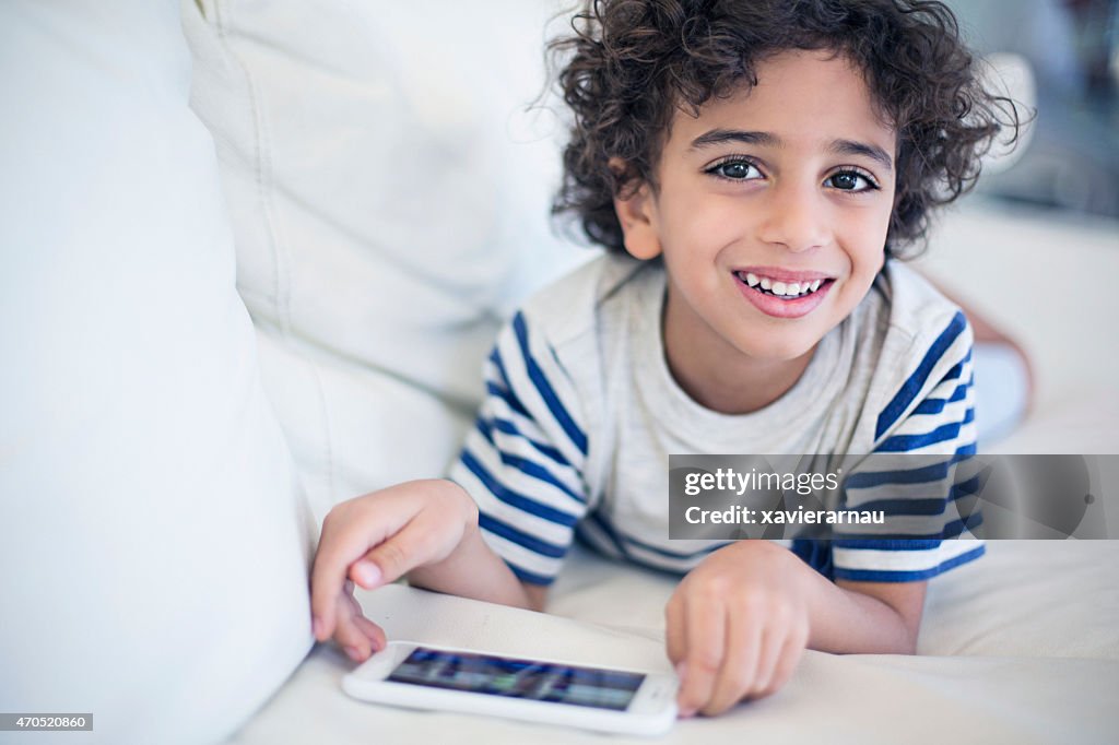 Happy kid playing with the mobile phone