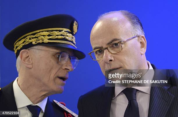 Paris police Prefect Bernard Boucault speaks to French Interior Minister Bernard Cazeneuve during the inauguration of a new police station on April...