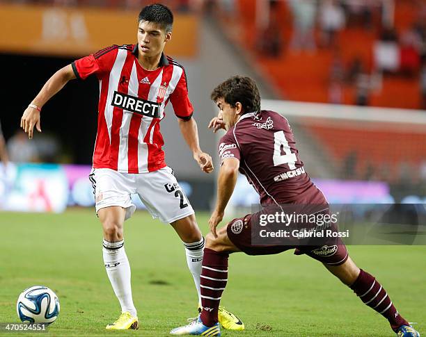 Joaquin Correa of Estudiantes fights for the ball with Carlos Araujo of Lanus during a match between Estudiantes and Lanus as part of third round of...