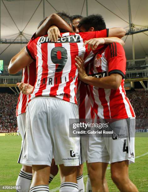 Guido Carrillo of Estudiantes celebrates with team mates after scoring the second goal of his team in a penalty kick during a match between...