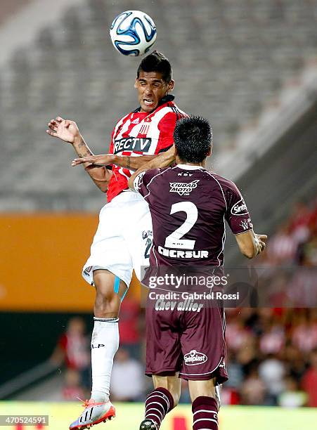 Franco Jara of Estudiantes jumps to head the ball during a match between Estudiantes and Lanus as part of third round of Torneo Final 2014 at Ciudad...