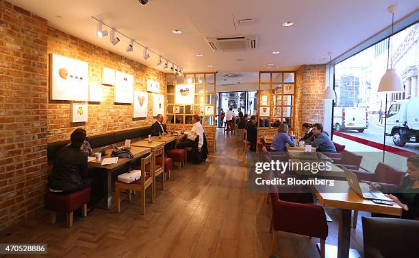 Customers sit inside a Pret A Manger sandwich store, operated by private equity firm Bridgepoint, in London, U.K., on Tuesday, April 21, 2015....