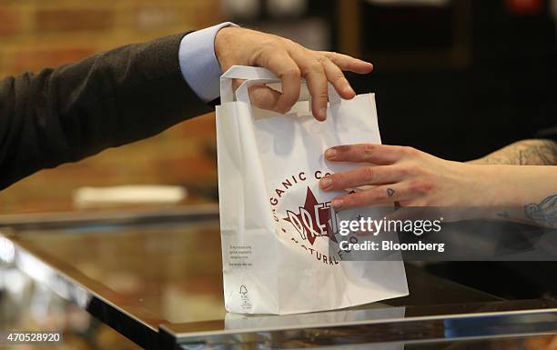 An employee, right, serves a customer inside a Pret A Manger sandwich store, operated by private equity firm Bridgepoint, in London, U.K., on...