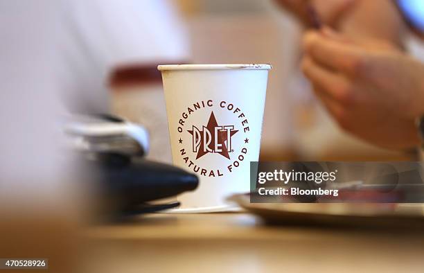 Coffee cup sits on a table inside a Pret A Manger sandwich store, operated by private equity firm Bridgepoint, in London, U.K., on Tuesday, April 21,...