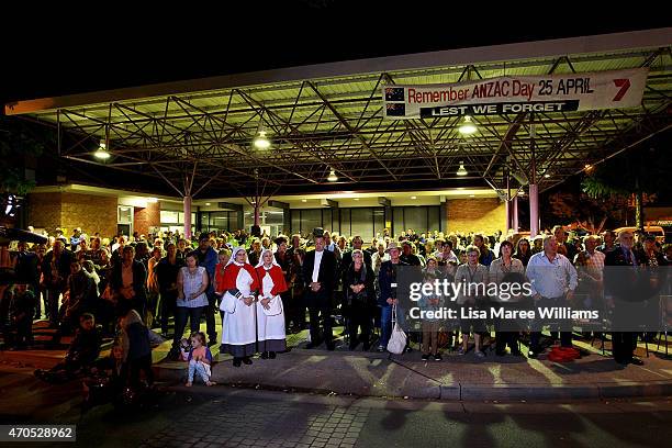 Troop Train passengers and members of the public stand in silence during a wreath laying ceremony on April 21, 2015 in Emerald, Australia. The 2015...