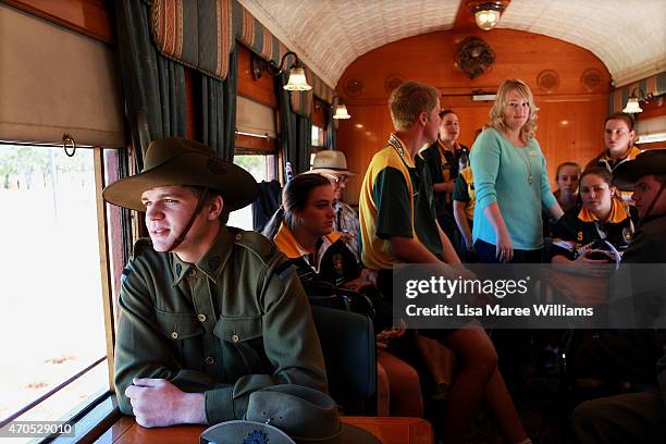 Members of the '9th Battalion AIF Living History Unit' from Rockhampton sit with high school children aboard the ANZAC Troop Train on April 21, 2015...