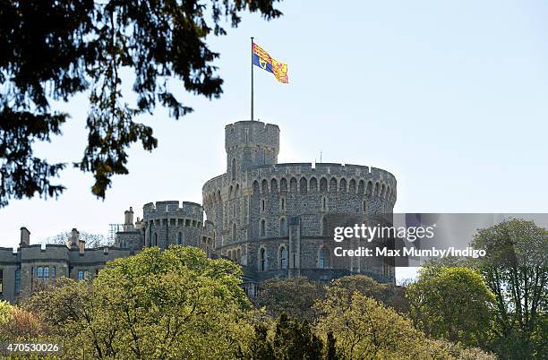 An oversized Royal Standard flies above the Round Tower of Windsor Castle to mark Queen Elizabeth II's 89th Birthday on April 21, 2015 in Windsor,...