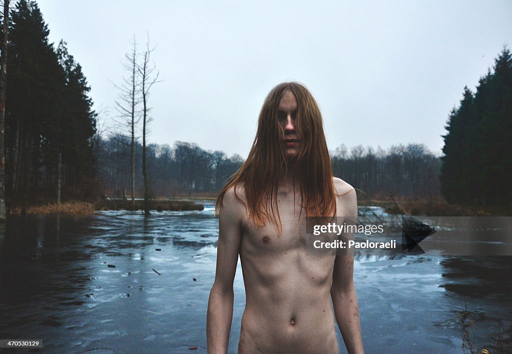 Long-haired boy in the swamp