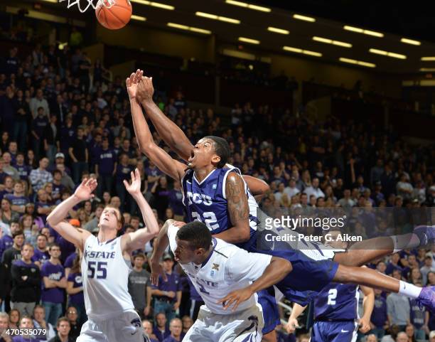 Guard Jarvis Ray of the TCU Horned Frogs leaps over guard Marcus Foster of the Kansas State Wildcats for a loose ball during the first half on...