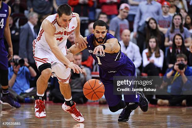 Aaron Craft of the Ohio State Buckeyes and Drew Crawford of the Northwestern Wildcats battle for control of a loose ball in the second half on...