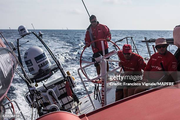 In this handout image provided by the Volvo Ocean Race, onboard MAPFRE. Andre Fonseca at the helm, Rafael Trujillo and Carlos Hernandez trimming. In...