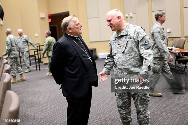 Thomas Wenski , Archbishop of Miami, speaks with U.S. National Guard Col. Laurence Bazer, Chaplain, Massachusetts National Guard, as they participate...