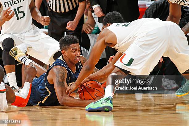 Eric Atkins of the Notre Dame Fighting Irish and Garrius Adams of the Miami Hurricanes battle for a loose ball on February 19, 2014 at the BankUnited...