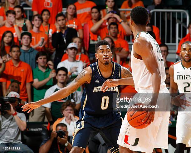 Eric Atkins of the Notre Dame Fighting Irish defends against Garrius Adams of the Miami Hurricanes during second half action on February 19, 2014 at...