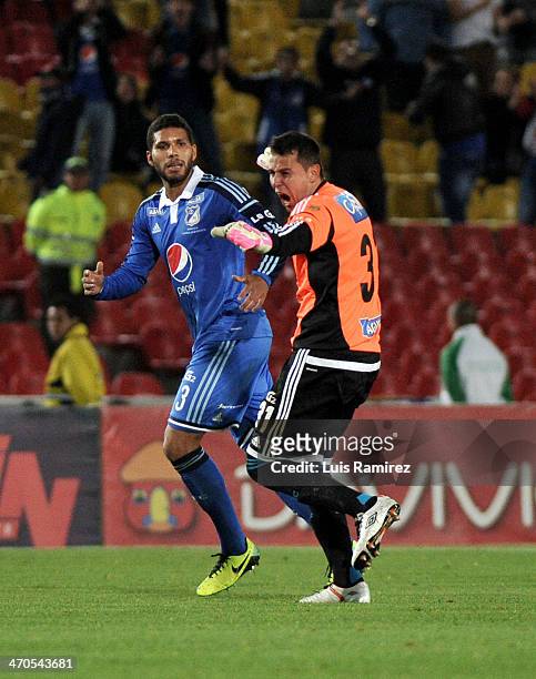Luis Delgado, goalkeeper of Millonarios and Oswaldo Henriquez celebrate after taking a penalty kick to score the first goal during a match between...