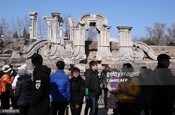 Visitors gather before the Great Fountain Ruins in the Old Summer Palace, known in Chinese as Yuan Ming Yuan, in Beijing on February 19, 2014. A...