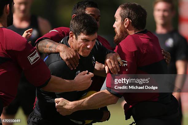 Quinten Lynch is tackled by Ben Hudson during a Collingwood Magpies AFL training session at Olympic Park on February 20, 2014 in Melbourne, Australia.