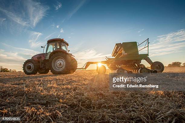 seeding at sunset - agricultural machinery stock pictures, royalty-free photos & images
