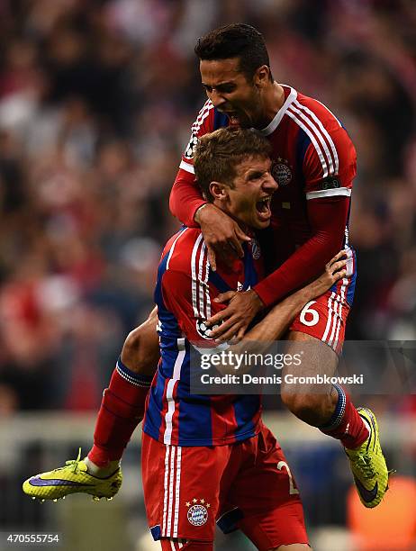 Thomas Mueller of Bayern Muenchen celebrates scoring their fourth goal with Thiago Alcantara of Bayern Muenchen during the UEFA Champions League...