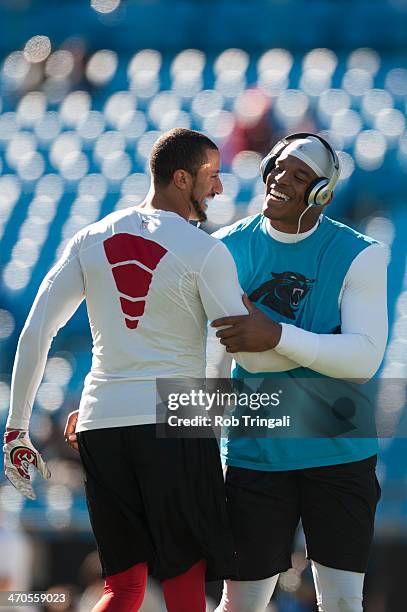 Colin Kaepernick of the San Francisco 49ers and Cam Newton of the Carolina Panthers talk before the NFC Divisional Playoff Game between the two teams...