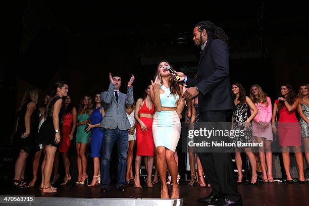 Model Chrissy Teigen and NFL player Richard Sherman onstage at Club SI Swimsuit at LIV Nightclub hosted by Sports Illustrated at Fontainebleau Miami...