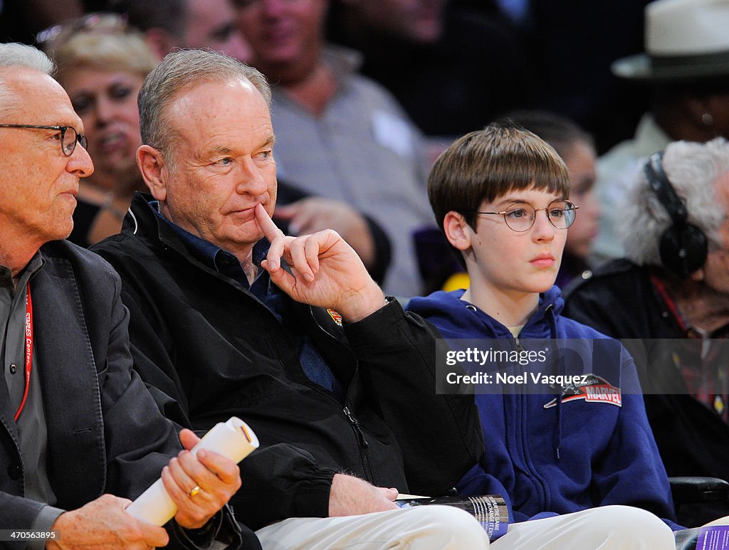 Bill O'Reilly and his son Spencer O'Reilly attend a basketball game
