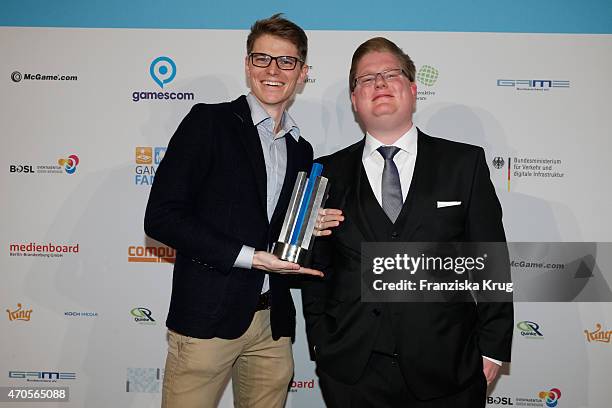 Peter Smits and Marek Ziemarek of 11Bit Studios poses with his award for Best International Game at the German Computer Games Award 2015 at e-Werk on...