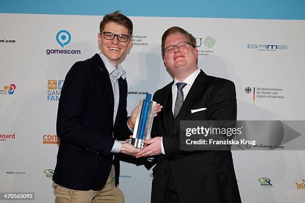 Peter Smits and Marek Ziemarek of 11Bit Studios poses with his award for Best International Game at the German Computer Games Award 2015 at e-Werk on...