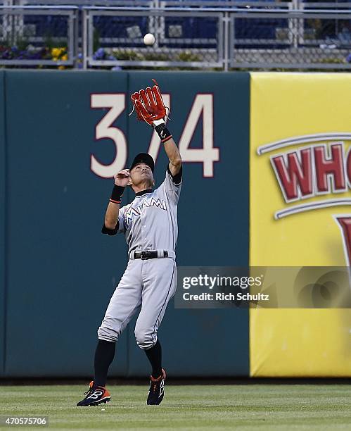 Left fielder Ichiro Suzuki of the Miami Marlins makes a catch on a ball hit by Carlos Ruiz of the Philadelphia Phillies during the first inning of a...