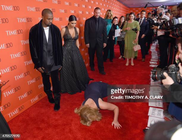 Honoree and Comedian Amy Schumer pretends to trip and fall on the floor in front of honorees Kim Kardashian and Kanye West as they attend the Time...