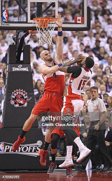 Marcin Gortat of the Washington Wizards denies Amir Johnson of the Toronto Raptors in Game Two of the Eastern Conference Quarterfinals during the...
