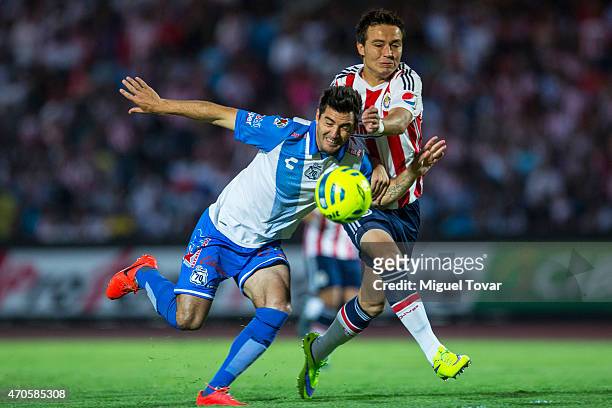 Luis Noriega of Puebla fights for the ball with Erick Torres of Chivas during a Championship match between Puebla and Chivas as part of Copa MX...
