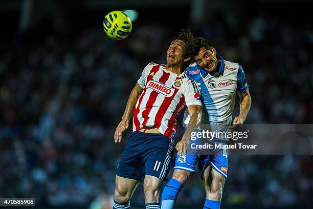 Facundo Erpen of Puebla fights for the ball with Aldo De Nigris of Chivas during a Championship match between Puebla and Chivas as part of Copa MX...