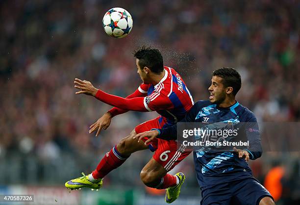 Thiago Alcantara of Bayern Muenchen jumps for a header with Casemiro of Porto during the UEFA Champions League Quarter Final Second Leg match between...