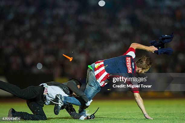 Fan of chivas invades the pitch during a Championship match between Puebla and Chivas as part of Copa MX Clausura 2015 at Olimpico Universitario BUAP...