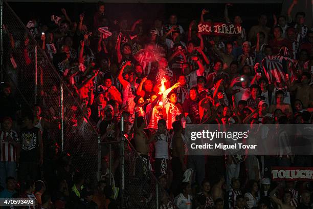 Fans of Chivas light a red flare during the Championship match between Puebla and Chivas as part of Copa MX Clausura 2015 at Olimpico Universitario...