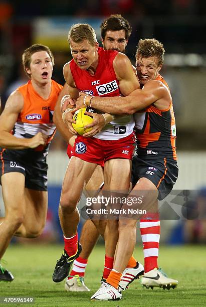 Rhys Palmer of the Giants tackles Ryan O'Keefe of the Swans during the round two NAB Cup AFL match between the Greater Western Sydney Giants and the...