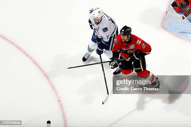 Dennis Wideman of the Calgary Flames skates against Daniel Sedin of the Vancouver Canucks at Scotiabank Saddledome for Game Four of the Western...