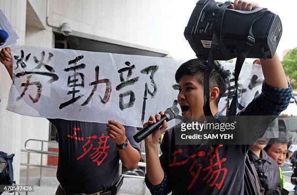 Protesters from a local labor union shouts slogans outside the parliament during a demonstration in Taipei on April 22, 2015. Workers from a factory...