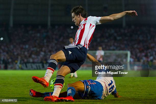 Michael Orozco of Puebla fights for the ball with Carlos Fierro of Chivas during a Championship match between Puebla and Chivas as part of Copa MX...