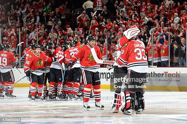 Goalies Corey Crawford and Scott Darling of the Chicago Blackhawks hug after defeating the Nashville Predators 3-2 in triple overtime, in which...