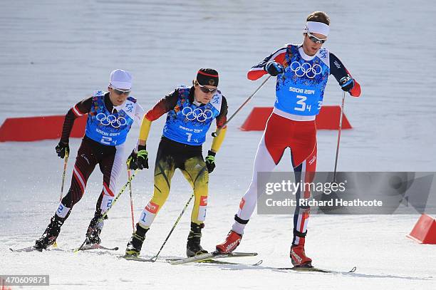 Mario Stecher of Austria, Fabian Riessle of Germany and Joergen Graabak of Norway compete in the Nordic Combined Men's Team 4 x 5 km during day 13 of...