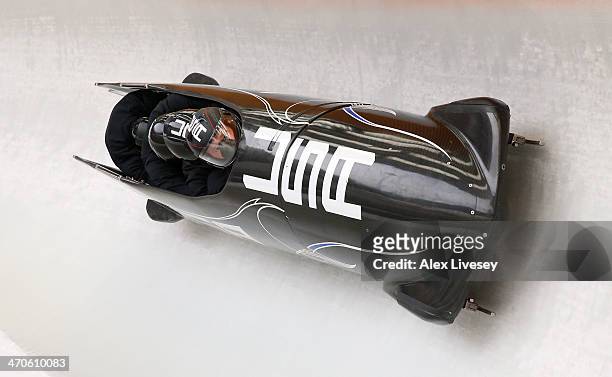 Steven Holcomb of USA pilots a run during a four-man bobsleigh practice session on Day 13 of the Sochi 2014 Winter Olympics at Sliding Center Sanki...