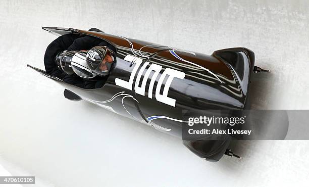 Nick Cunningham of USA pilots a run during a four-man bobsleigh practice session on Day 13 of the Sochi 2014 Winter Olympics at Sliding Center Sanki...