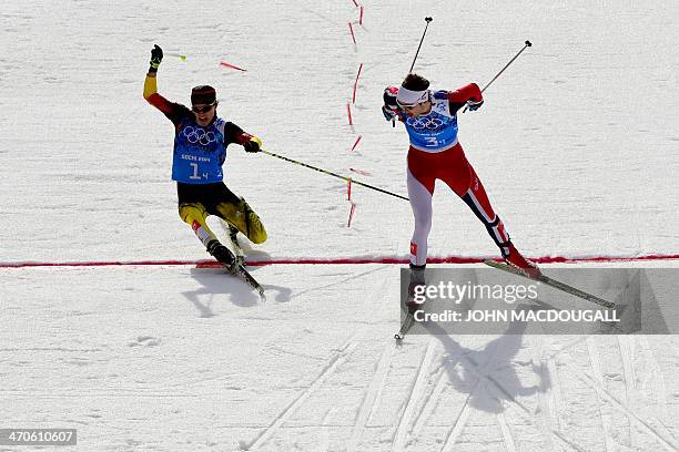 Silver medalist Germany's Fabian Riessle and Gold medalist Norway's Joergen Graabak cross the finish line in the Nordic Combined Team LH / 4x5 km...