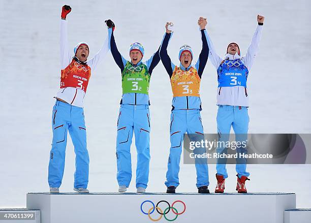 Gold medalists Magnus Hovdal Moan, Haavard Klemetsen, Magnus Krog and Joergen Graabak of Norway celebrate during the flower ceremony for the Nordic...