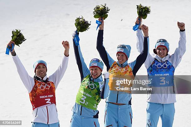 Gold medalists Magnus Hovdal Moan, Haavard Klemetsen, Magnus Krog and Joergen Graabak of Norway celebrate during the flower ceremony for the Nordic...