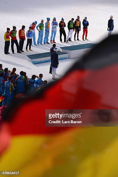 Silver medalists Germany, gold medalists Norway and bronze medalists Austria celebrate during the flower ceremony for the Nordic Combined Men's Team...